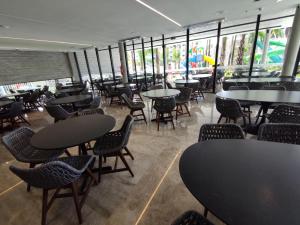 a dining room with tables and chairs and windows at Ap particular 1001 ou 1201 no Salinas Premium Resort in Salinópolis
