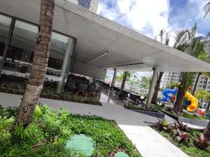 a building with a slide in the middle of a courtyard at Ap particular 1001 ou 1201 no Salinas Premium Resort in Salinópolis