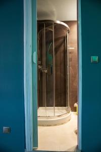 a shower with a glass door in a bathroom at The North Apartment in Kastoria