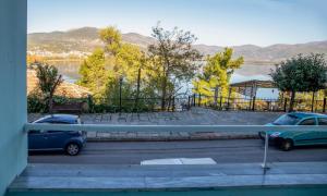 two cars parked in a parking lot next to a lake at The North Apartment in Kastoria