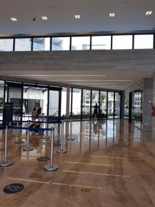 a lobby with tables and chairs in a building at Ap particular 1001 ou 1201 no Salinas Premium Resort in Salinópolis +45 photos