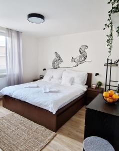 a bedroom with a bed with two horses on the wall at Apartmány Minoris in Liptovský Mikuláš