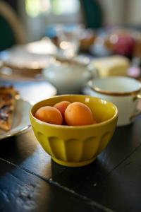 a yellow bowl of eggs on a wooden table at Le Parc du Magnolia in Montbéliard
