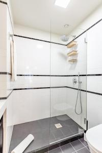 a glass shower in a bathroom with a toilet at Welcome Aliados a Noble apartment in City Heart in Porto