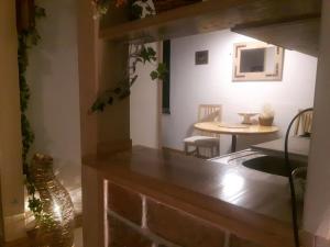 a kitchen with a counter with a table and a dining room at Woody in Valjevo