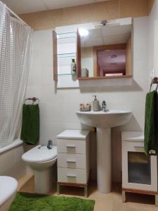 a bathroom with a sink and a toilet and a mirror at Precioso apartamento en primera línea de playa in San Blas