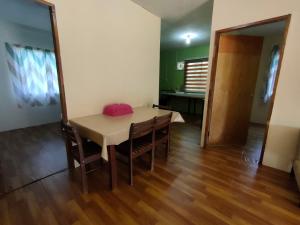 a dining room with a table and chairs and a room at Orchard View Guesthouse Tambunan in Tambunan