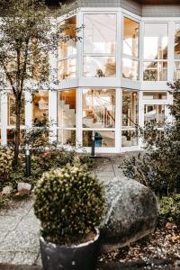 a building with a large window and a rock at Akzent Hotel Zur Grünen Eiche in Bispingen