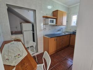 a small kitchen with a table and a sink at Sunny Churriana-Airport II in Málaga