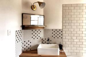 a bathroom with a white sink and a mirror at NATIFRIENDLY-Appartement centre historique avec jardin IDEAL FAMILLE in Bellême