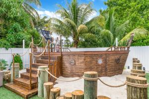 a wooden boat in a yard with wooden logs at Modern Miami Home 10 Min to the AIRPORT L03 in Miami