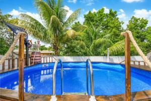 a swimming pool with a wooden fence and a blue swimming pool at Modern Miami Home 10 Min to the AIRPORT L03 in Miami