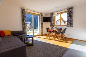 a living room with a couch and a table at Ferienwohnung Wallner in Wald am Arlberg