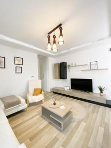 a living room with a couch and a table at Luxury Apartment with Private Parking in Giroc