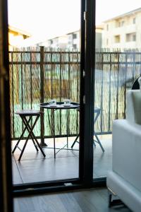 a table and two chairs on a balcony at Luxury Apartment with Private Parking in Giroc