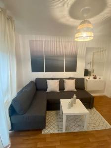 a living room with a blue couch and a table at Superbe Appartement cosy et calme avec un parking in Corbeil-Essonnes