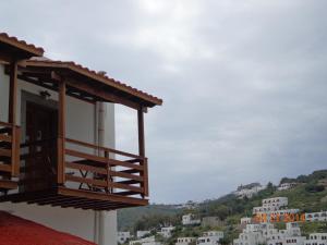 a balcony on the side of a building with a mountain at Mistral-Patmos in Patmos