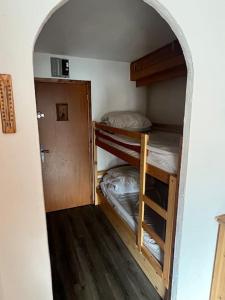 a small room with two bunk beds in it at Glaciers / 4 persons apartment in Val Thorens