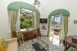 a living room with a desk and a window at Casa Teresa in Positano