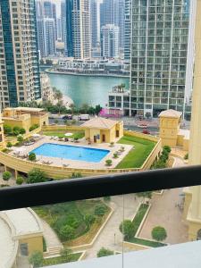 a view from a balcony of a building with a pool at Luxury Casa - Gem Marina View Apartment 1-bedroom JBR Beach in Dubai