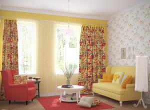 a living room with a yellow couch and a red chair at Edem Apartmants in Lviv 2 in Lviv