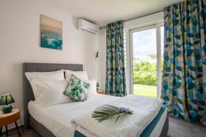 Postel nebo postele na pokoji v ubytování Hôtel Guadeloupe Palm Suites + 37 fotografií
