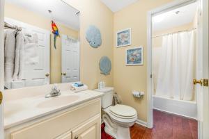 a bathroom with a toilet and a sink and a shower at Boatin' n Fishin' in Panama City Beach +10 photos