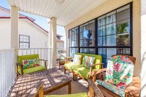 a porch with green chairs and windows at Boatin' n Fishin' in Panama City Beach