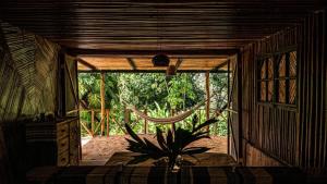 a room with a plant in a room with a window at Finca Vista Hermosa - Deluxe Bamboo Cabana in Pluma Hidalgo