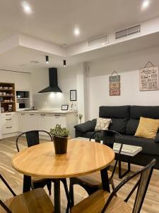 a living room with a table and chairs and a couch at VELALMA PISOS centro histórico -LA CATEDRAL ALOJAMIENTOS- in Jaén