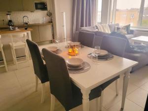a dining room table with chairs and a table with wine glasses at Gezellig appartement in Brugge, nabij Damme. in Bruges +5 photos