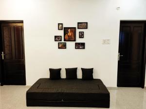 a bedroom with a bed with pictures on the wall at Happy Buddha S4 in Varkala