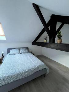 um quarto com uma cama num quarto branco em Charmant duplex lumineux - Centre de Carquefou em Carquefou