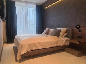 a bedroom with a large bed and a window at Woodside Kopaonik by Ister in Kopaonik +23 photos