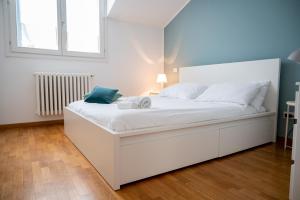 a large white bed in a room with a window at Trilocale zona Farini/Isola in Milan