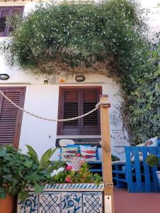 a building with a balcony with a window and plants at VILLA CORALLINA in San Vito lo Capo