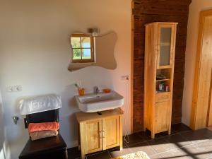 a bathroom with a sink and a mirror at Berghütte, Chalet - Schwarzenberg am Böhmerwald in Schwarzenberg am Bohmerwald