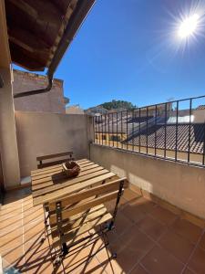 a wooden table on a balcony with a view of a stadium at Dúplex Teresa in Alcañiz