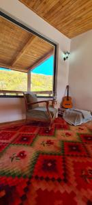a room with a chair and a large window at Racha Cornfield House in Oni