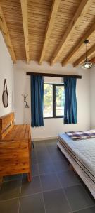a bedroom with a bed and a large window at Racha Cornfield House in Oni