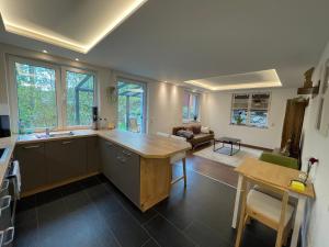 a kitchen with a table and a living room at Ferienwohnung Zur Wupper in Wipperfürth