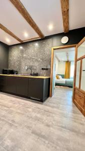 a kitchen with a sink and a counter top at Apartamenty Katowicka 38 in Świętochłowice