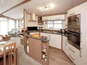 a kitchen with a counter top and a stove top oven at Family breaks at Rockley Park with Prosecco and a box of chocolates on arrival in Poole