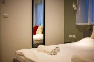 a bedroom with a mirror and two beds with towels at family apartment Dead-sea view in Ovnat