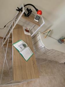 a room with a desk with a book and a lamp at IL Lago dei sogni in Posta Fibreno