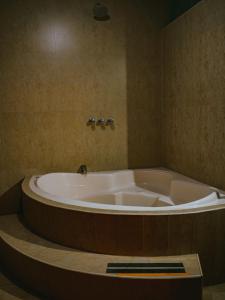 a bath tub in a bathroom with a large tub at Marzano in Cajamarca
