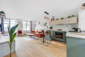 an open kitchen and living room with a couch at A place to chill in Paris