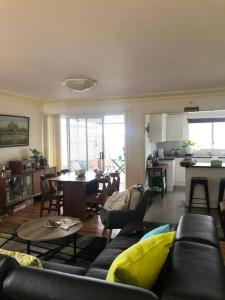 a living room with a couch and a table at Relaxing cottage overlooking Crookhaven River in Greenwell Point