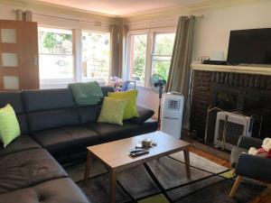a living room with a couch and a fireplace at Relaxing cottage overlooking Crookhaven River in Greenwell Point