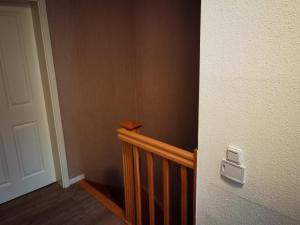 a room with a stairway with a door and a stair railing at Modernes behagliches Haus mit Kamin, Terrasse und Garten in Magdeburg
